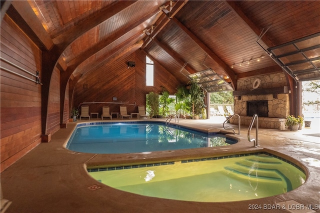 view of pool featuring a patio and an outdoor stone fireplace