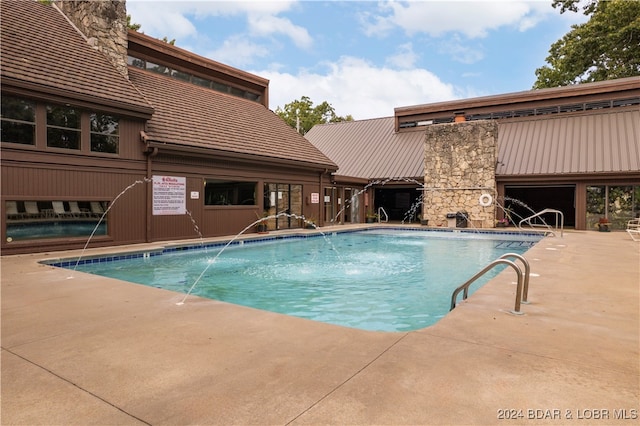 view of pool featuring a patio and pool water feature