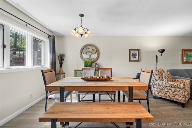 dining space featuring hardwood / wood-style floors and a chandelier