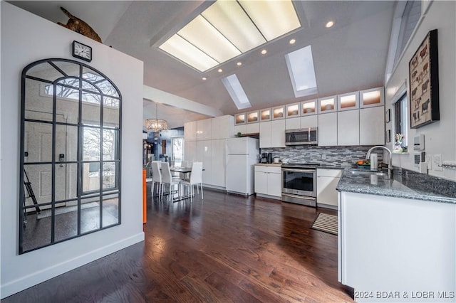 166 Falls Point Dr Unit 2B, Lake Ozark, MO 65049 - kitchen featuring stainless steel appliances, vaulted ceiling, a sink, white cabinetry, and recessed lighting