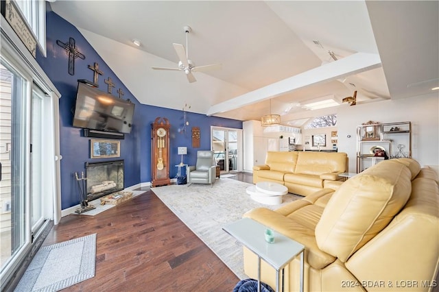 166 Falls Point Dr Unit 2B, Lake Ozark, MO 65049 - living room featuring ceiling fan, dark wood-type flooring, a glass covered fireplace, baseboards, and high vaulted ceiling