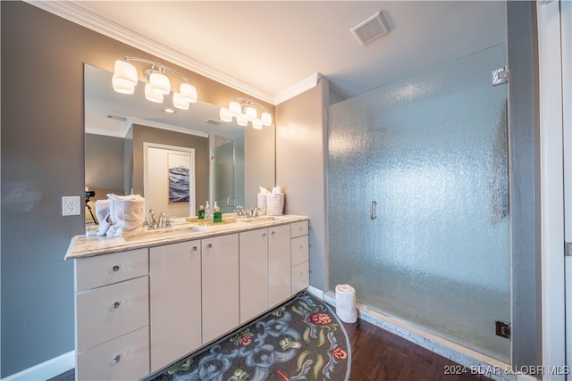 bathroom with wood-type flooring, vanity, and ornamental molding