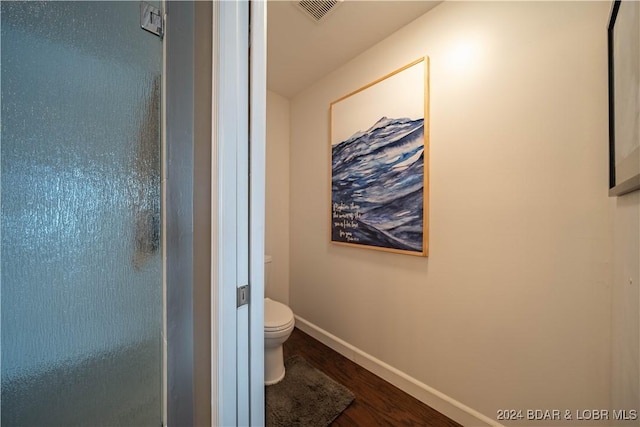 166 Falls Point Dr Unit 2B, Lake Ozark, MO 65049 - bathroom featuring wood finished floors, toilet, baseboards, and a shower