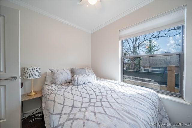 bedroom with crown molding, hardwood / wood-style floors, and ceiling fan