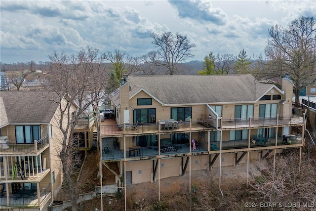 166 Falls Point Dr Unit 2B, Lake Ozark, MO 65049 - back of house with a chimney and a shingled roof