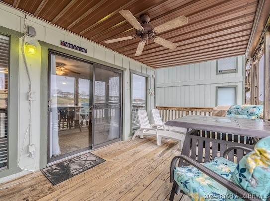 wooden deck featuring ceiling fan