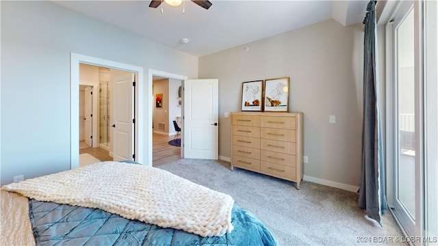 bedroom featuring connected bathroom, lofted ceiling, ceiling fan, and light colored carpet