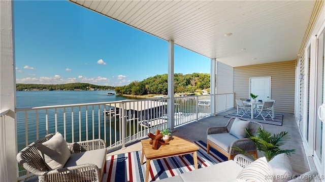 balcony featuring a water view and an outdoor hangout area