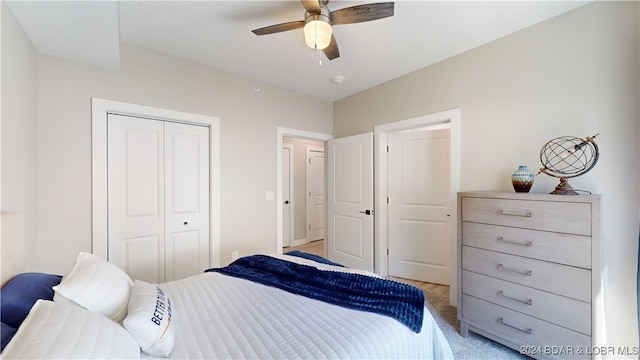 carpeted bedroom featuring a closet and ceiling fan