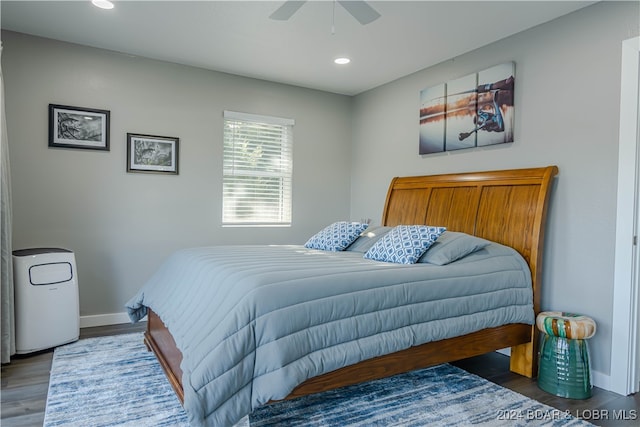 bedroom with ceiling fan and dark wood-type flooring