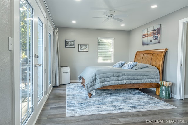 bedroom with ceiling fan, dark hardwood / wood-style floors, and access to outside