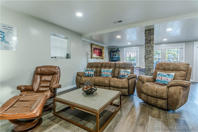 living room featuring hardwood / wood-style floors and ornate columns