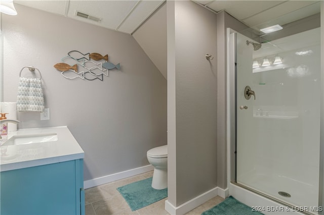 bathroom with an enclosed shower, a paneled ceiling, tile patterned floors, vanity, and toilet