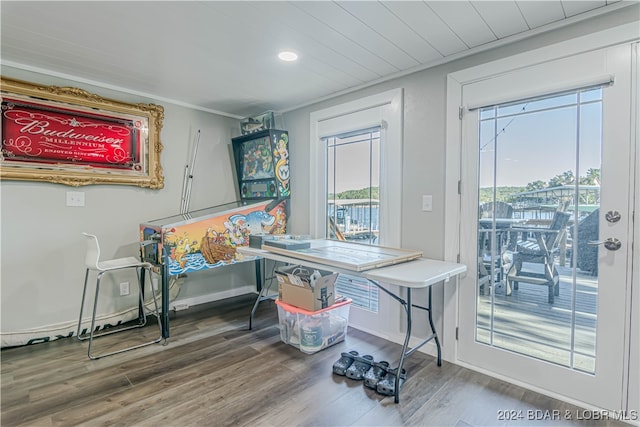 dining space featuring ornamental molding and hardwood / wood-style floors