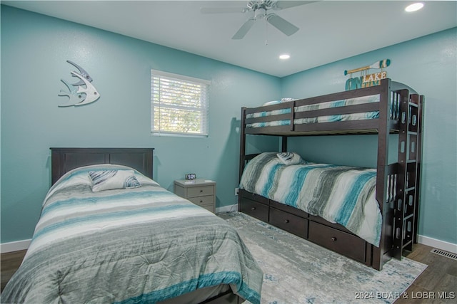 bedroom with ceiling fan and dark hardwood / wood-style floors