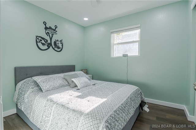 bedroom with ceiling fan and dark hardwood / wood-style floors