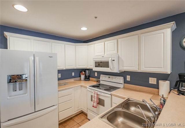 kitchen with sink, white appliances, and white cabinetry