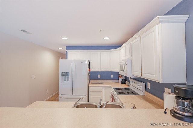 kitchen featuring white cabinets, white appliances, and sink