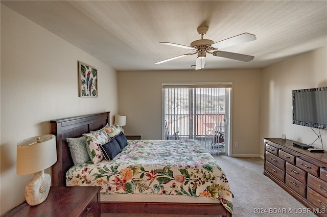 carpeted bedroom with ceiling fan and access to outside