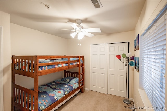 carpeted bedroom with a closet and ceiling fan