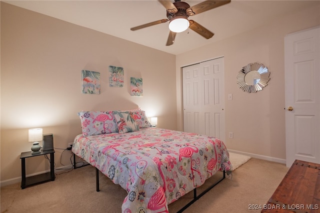 carpeted bedroom with a closet and ceiling fan