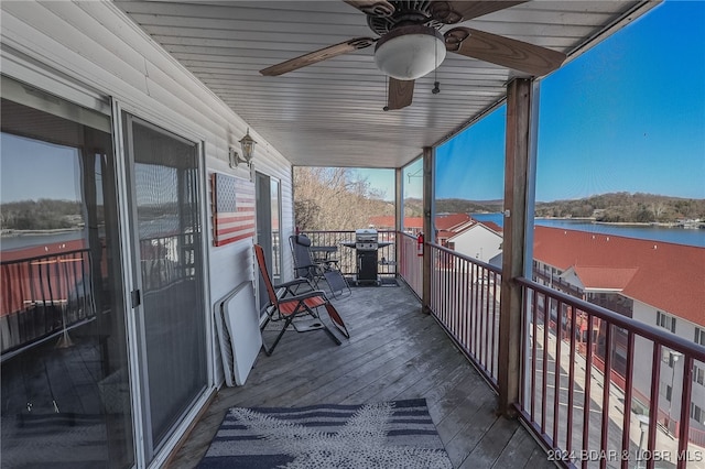 balcony with a water view and ceiling fan