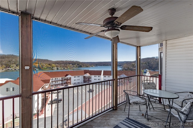 balcony with a water view and ceiling fan