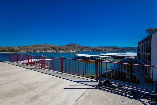 view of patio / terrace with a water and mountain view