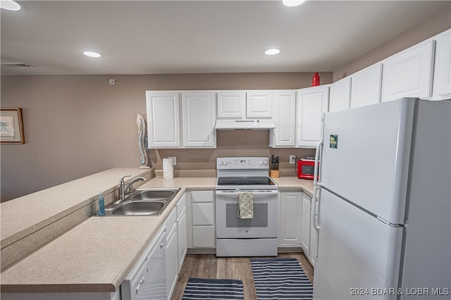 kitchen featuring kitchen peninsula, sink, white appliances, and white cabinetry