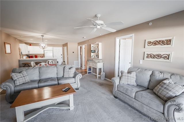 carpeted living room with ceiling fan