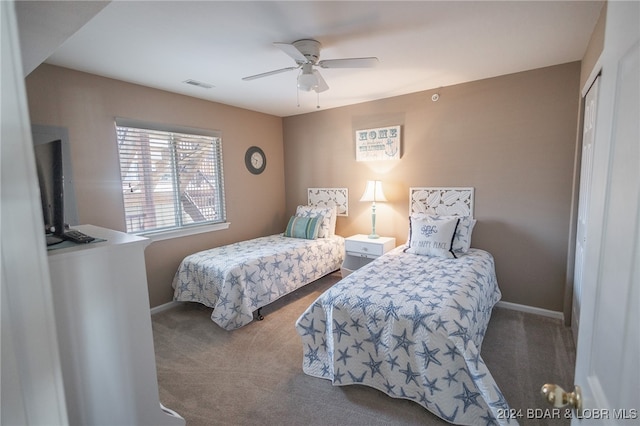 carpeted bedroom with ceiling fan and a closet