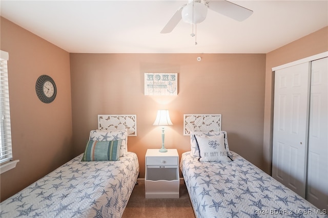 carpeted bedroom featuring ceiling fan and a closet