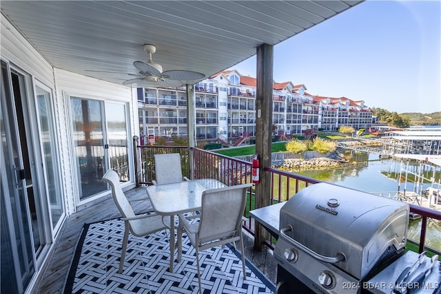 balcony with a water view, ceiling fan, and area for grilling