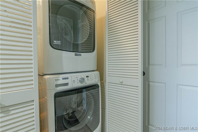 laundry room featuring stacked washer / drying machine