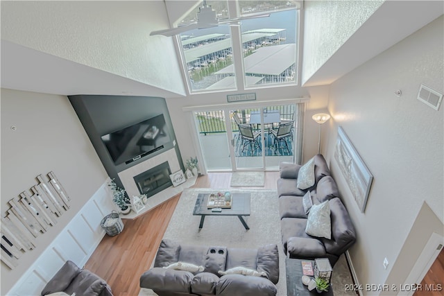 living room featuring a high ceiling and hardwood / wood-style flooring