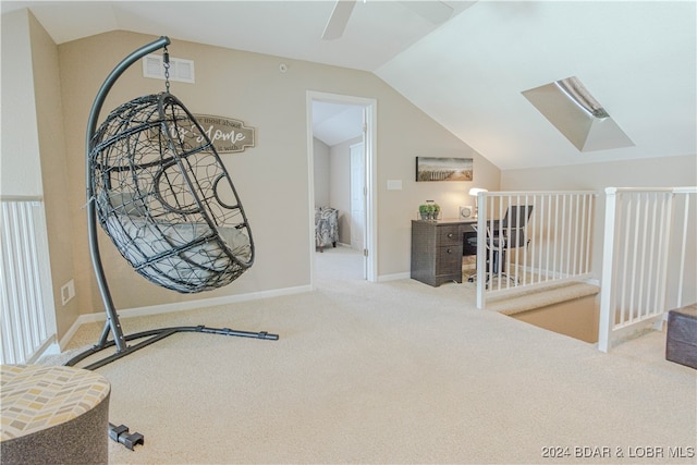 hallway featuring light colored carpet and lofted ceiling with skylight