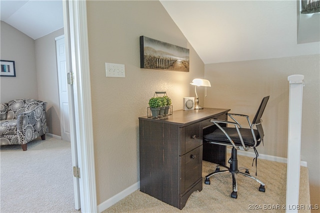 office space with vaulted ceiling and light carpet