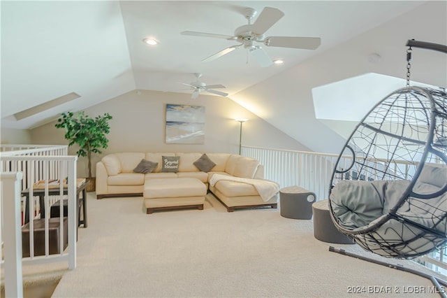 carpeted living room featuring lofted ceiling with skylight and ceiling fan