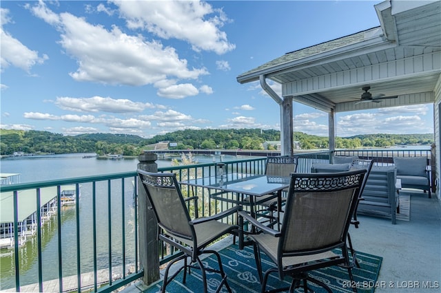 wooden terrace featuring a water view and ceiling fan