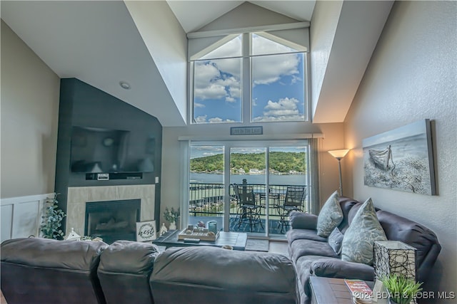 living room with lofted ceiling and a fireplace