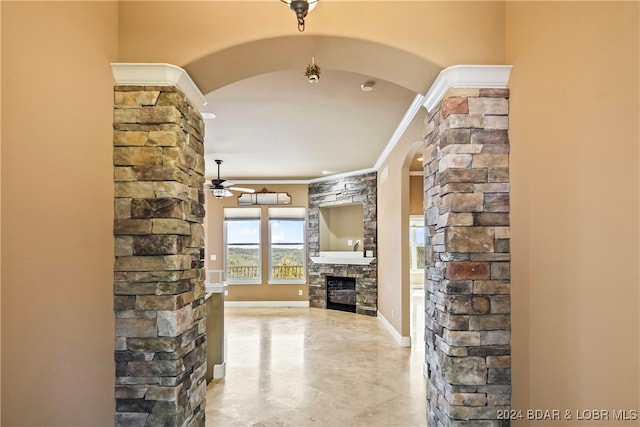 hall with decorative columns and crown molding