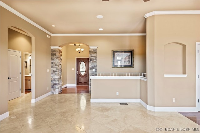 foyer featuring a notable chandelier and crown molding