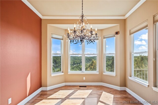 unfurnished dining area with light hardwood / wood-style floors and a healthy amount of sunlight