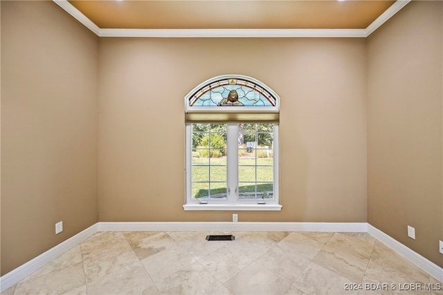 empty room featuring crown molding