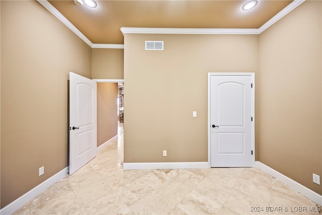 unfurnished bedroom with a textured ceiling and crown molding