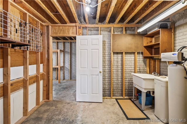 basement with brick wall