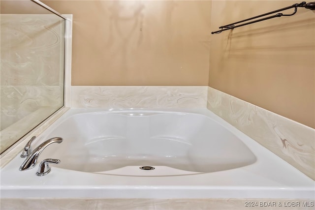 bathroom featuring a tub to relax in