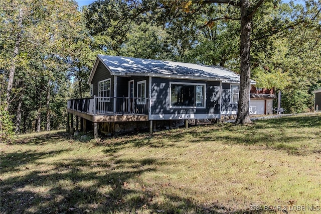 exterior space featuring a lawn and a deck