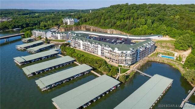 birds eye view of property featuring a water view and a view of trees