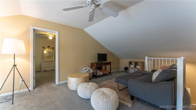 living room with lofted ceiling, carpet, and baseboards